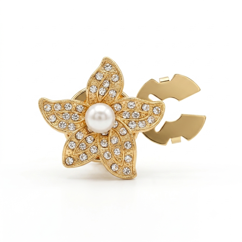 A gold flower-shaped hair claw clip decorated with clear rhinestones and a central white faux pearl, shown on a clean white background.