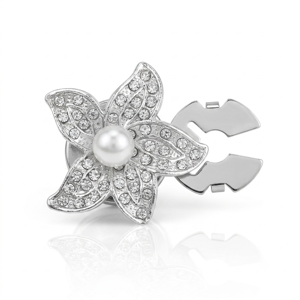 A silver-toned flower-shaped hair claw clip decorated with clear rhinestones and a central white pearl, shown on a clean white background with a soft reflection.