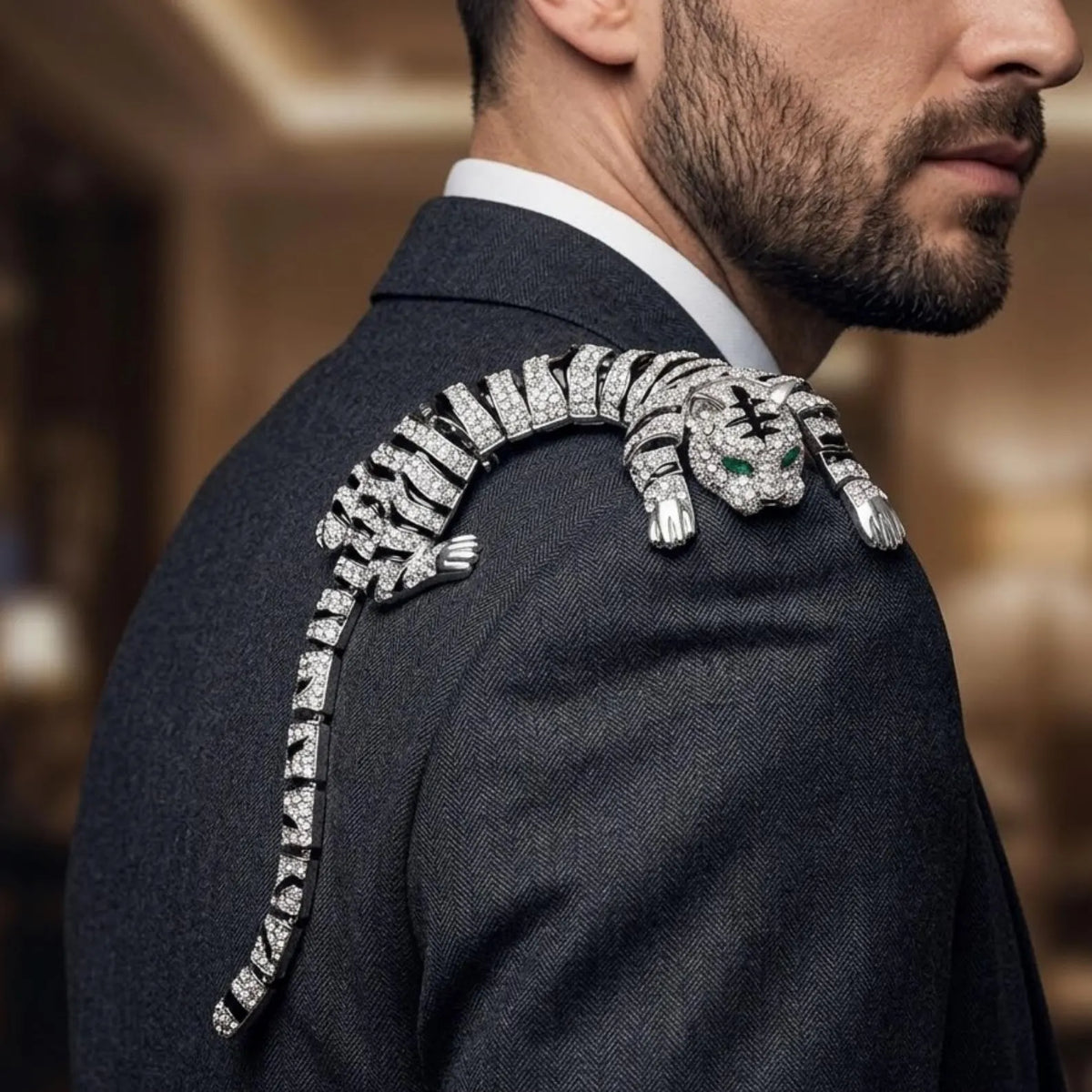 A close-up lifestyle shot of a man wearing a dark gray suit jacket, showing a highly detailed, diamond-encrusted tiger brooch resting on his shoulder.